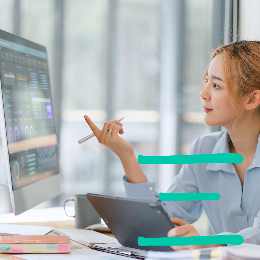 a person sitting at a desk in front of a computer screen