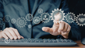 A person interacting with a digital interface showing a series of gears with icons representing business concepts like ideas, targets, and teamwork.